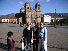 Heather, Jennifer, and Janet in the Plaza de Armas, Cusco. A native boy is desperately trying to sell us postcards.