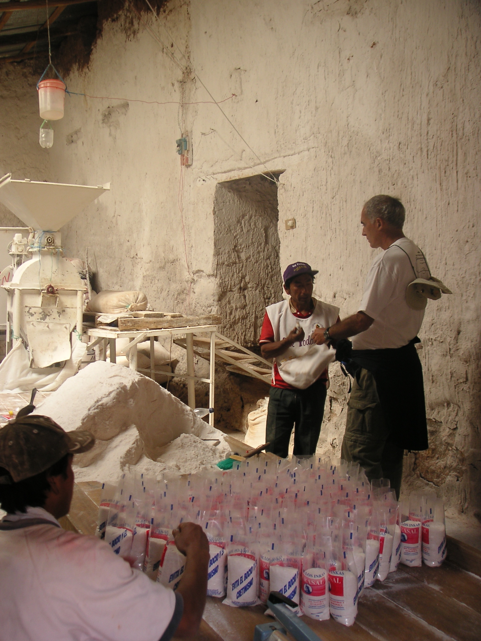 Carlos negotiates with the workers to allow us to buy individual bags of salt.