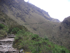 The trail leads to a mountain pass. In this picture, there are actually (tiny) people from our group resting at the mountain pass before hiking down the other side of the mountain.