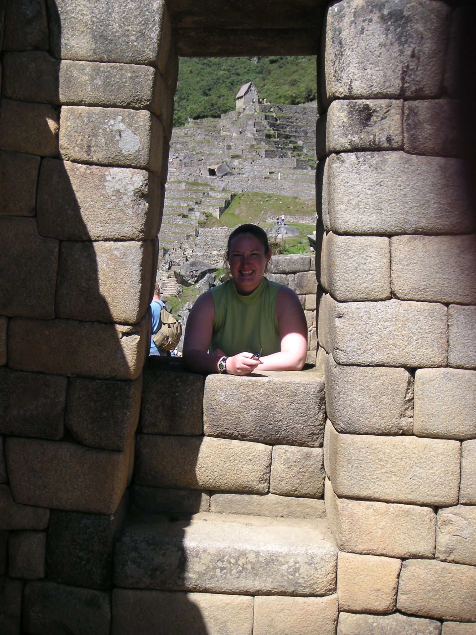 Janet posing in a window at Machu Picchu.