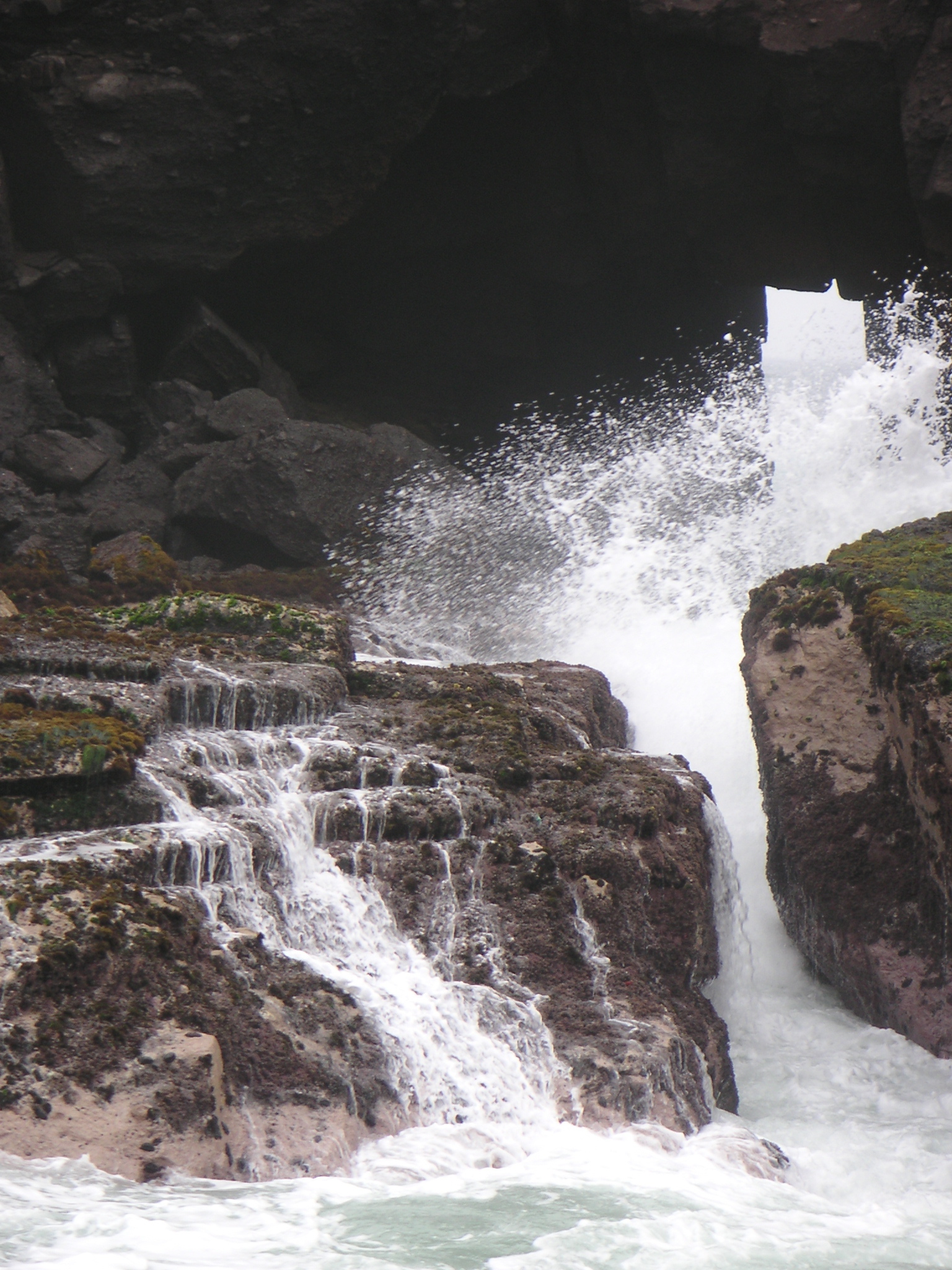 The inlet at Pucusana. Waves come through this small opening and crash over the rocks.